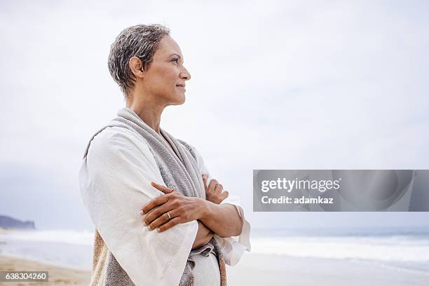 senior black woman relaxing on beach - meditation space stock pictures, royalty-free photos & images