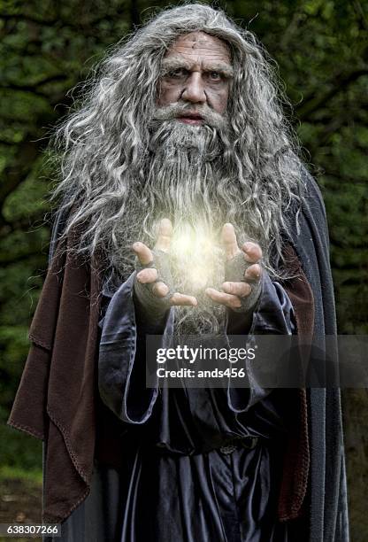 wizard casting light spell - wizzard stock pictures, royalty-free photos & images