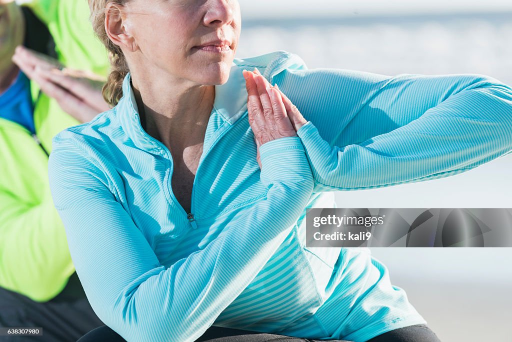 Cropped view of mature woman doing yoga