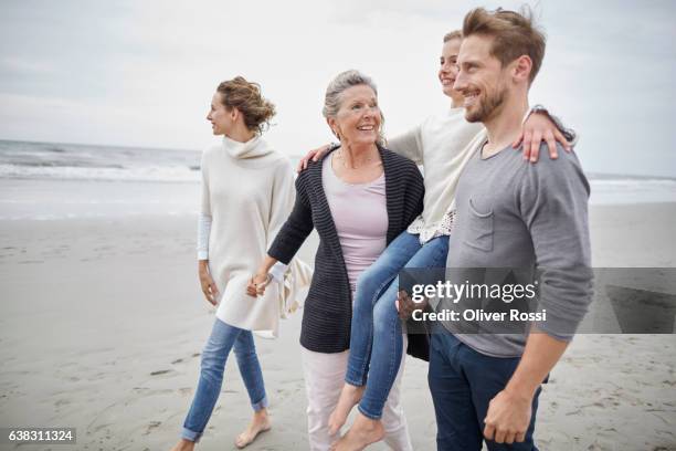 happy three-generation family on the beach - svärmor bildbanksfoton och bilder