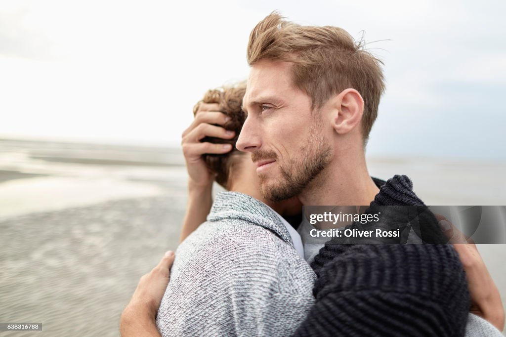 Couple hugging on the beach