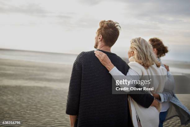 couple and senior woman on the beach - sogra imagens e fotografias de stock