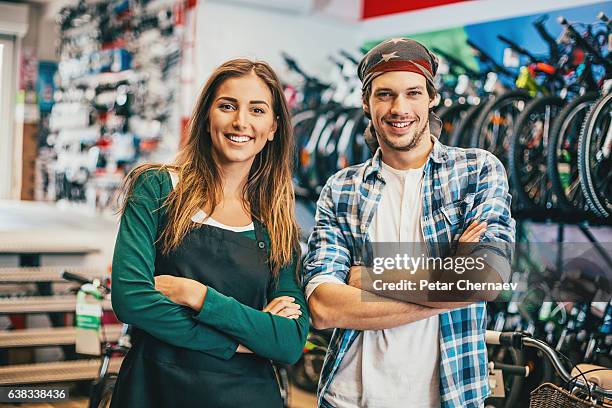 young couple running a bike shop - sales competition stock pictures, royalty-free photos & images