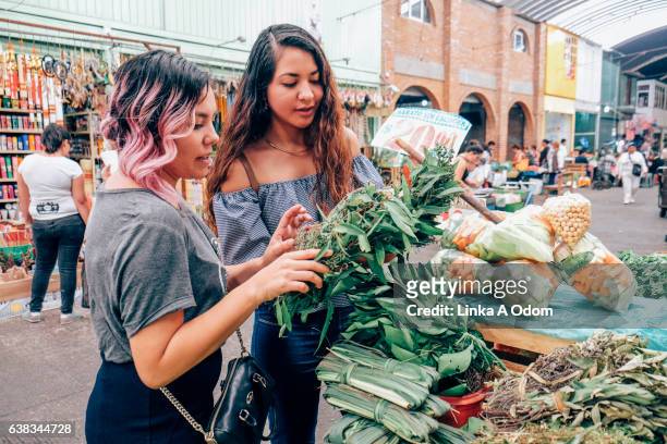 friends shopping together in market - mexican food stock-fotos und bilder
