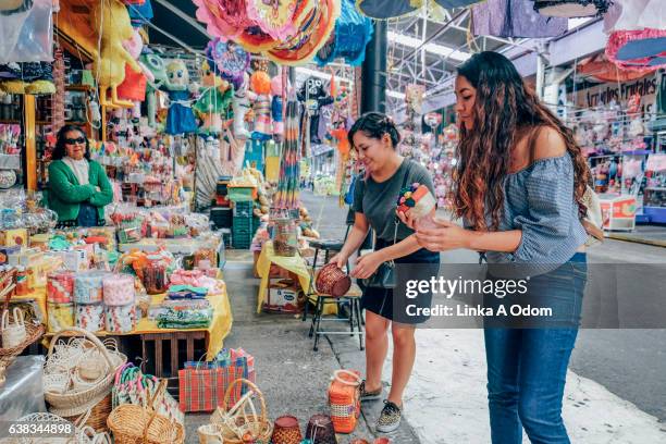 two females shopping together in market - mexico market stock pictures, royalty-free photos & images