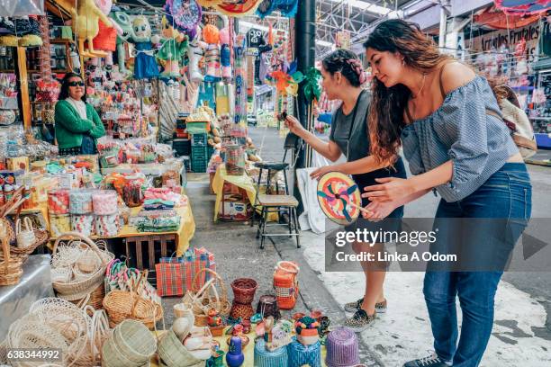 two females shopping together in market - flea market stock pictures, royalty-free photos & images