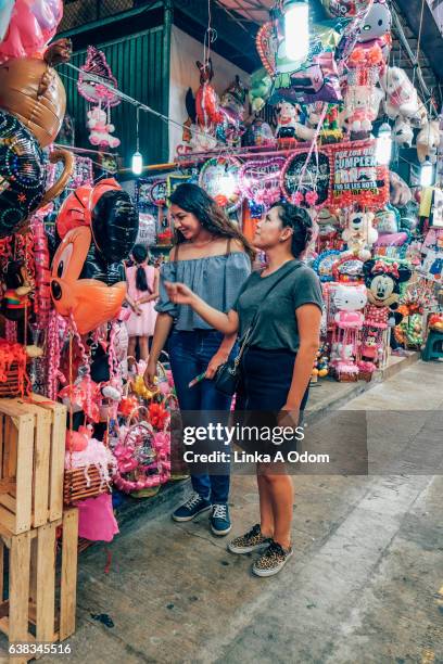 two females shopping together in market - mexico market stock pictures, royalty-free photos & images