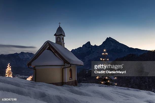christmas chapel in front of watzmann - country christmas stock pictures, royalty-free photos & images