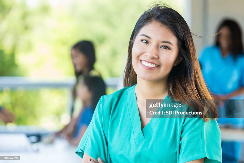 Confident Asian nurse works at outdoor health expo