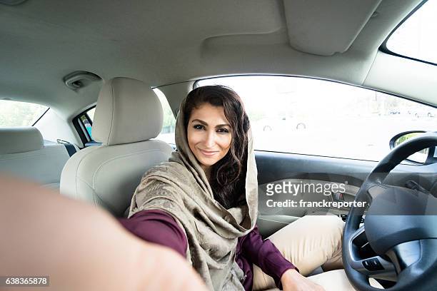 woman driving the car in abu dhabi - arab car stock pictures, royalty-free photos & images