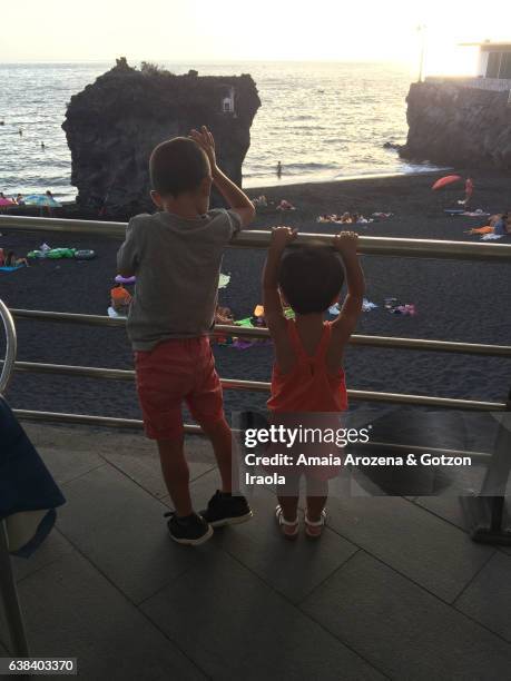 two small brothers in puerto naos at sunset. la palma island, canary islands. spain - puerto naos stock pictures, royalty-free photos & images