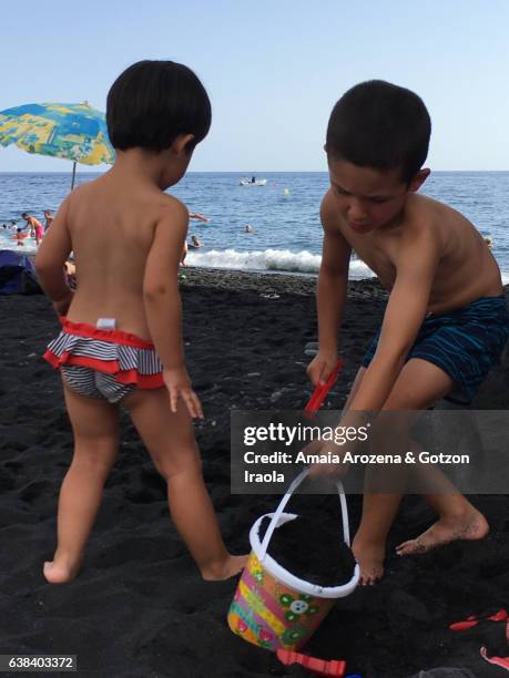 two small brothers playing in puerto naos beach. la palma island, canary islands. spain - puerto naos stock pictures, royalty-free photos & images