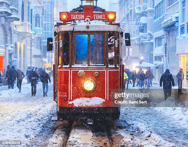 winter and red tram in istiklal street, beyoglu, istanbul. - beyoglu tram stock pictures, royalty-free photos & images