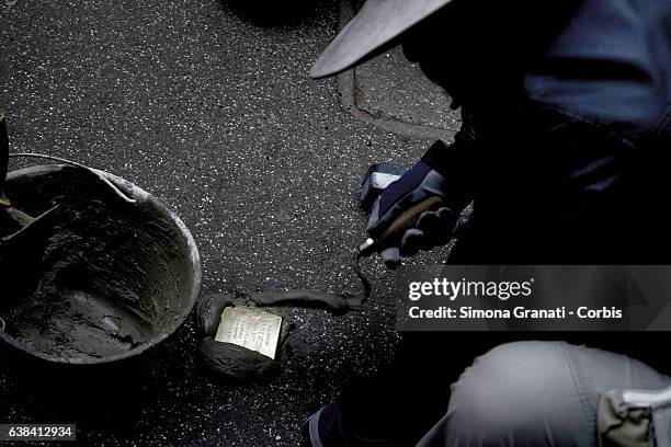 German artist Gunter Denming installs the stumbling blocks in Via Acqua Bullicante in Torpignattara in front of the house of partisan Valerio...