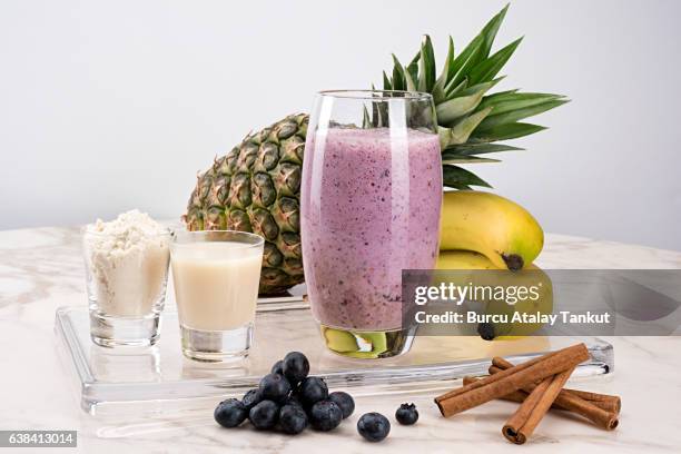 cranberry, pineapple, banana smoothie with protein powder, soy milk and cinnamon - protein drink stock pictures, royalty-free photos & images