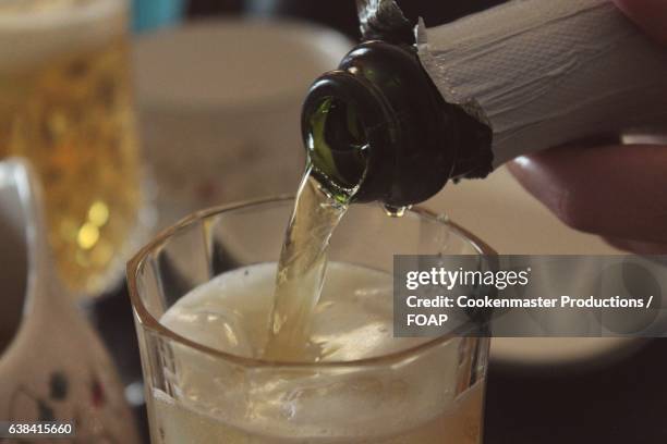 person pouring apple cider - wine glass finger food stock-fotos und bilder