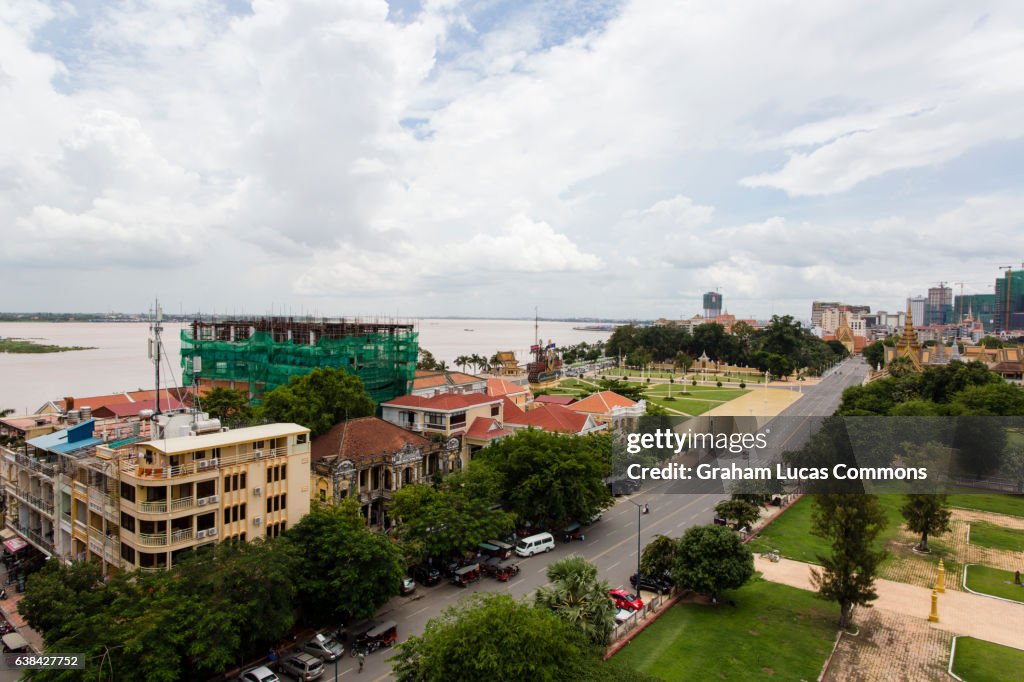 Looking South-East over Phnom Penh skyline towards the Tonle Sap and Mekong River and Wat Botum Park opposite the Royal Palace.