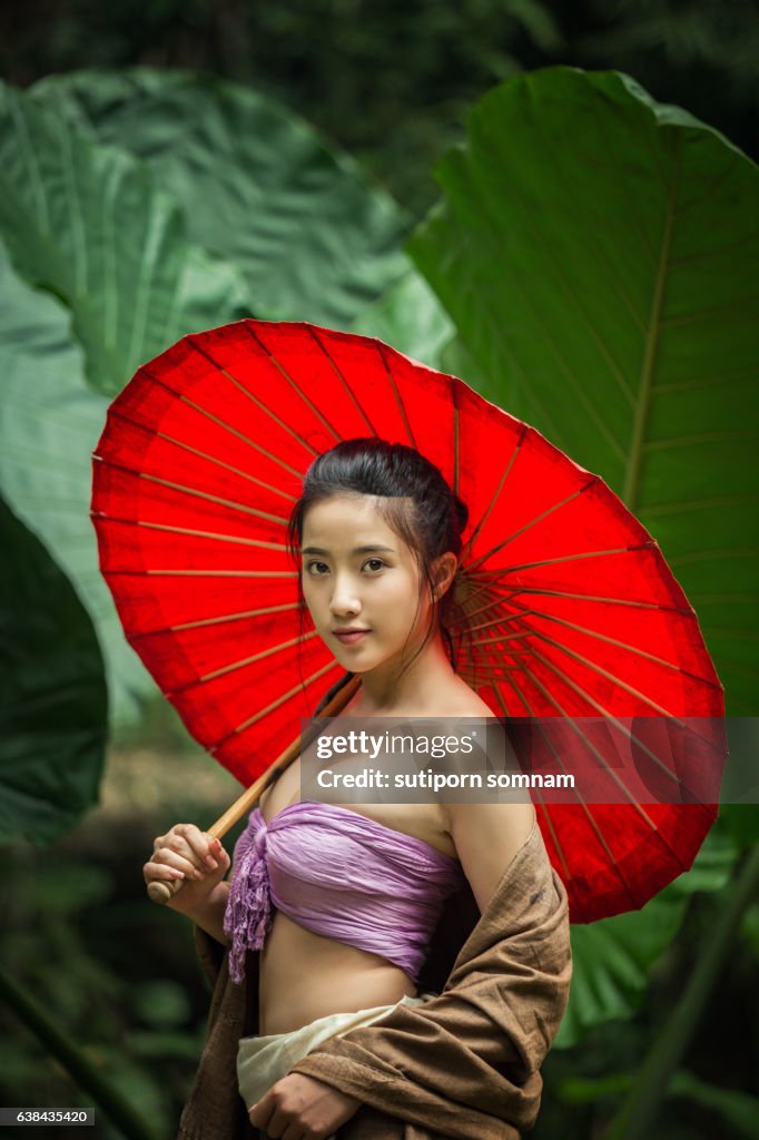 Asain woman holding red umbrella