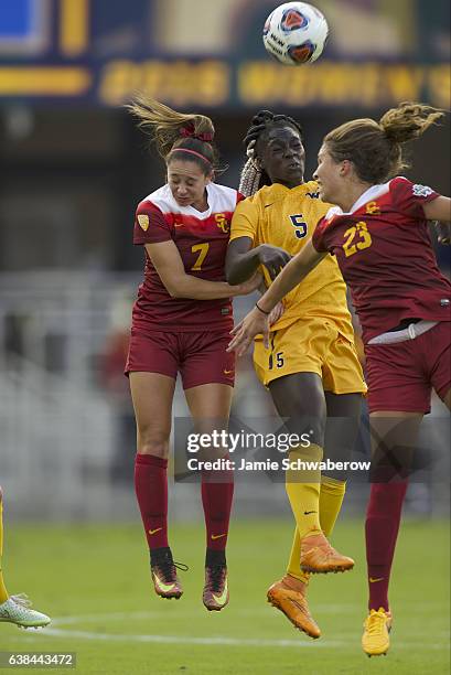 Julia Bingham and Ally Prisock of the University of Southern California and Michaela Abam of West Virginia University battle for the ball during the...