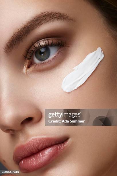 close up of a woman with cream on her face - menschliches gesicht fotografías e imágenes de stock