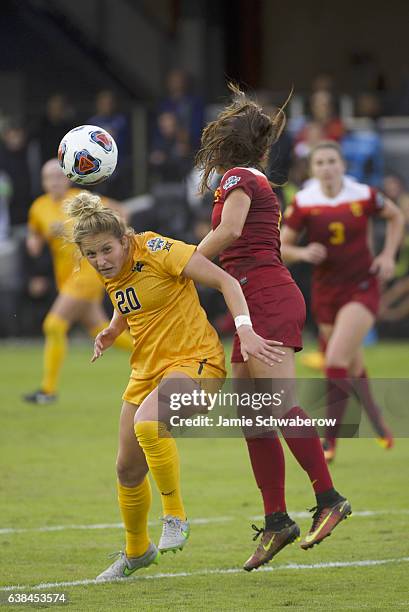 Julia Bingham of the University of Southern California and Hannah Abraham of West Virginia University battle for the ball during the Division I...