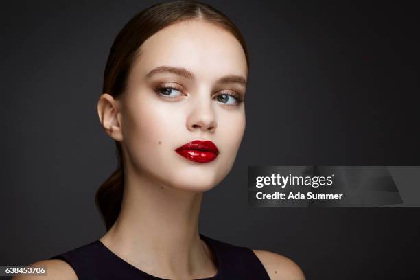 young beautiful woman with red glossy lips - menschliches gesicht fotografías e imágenes de stock
