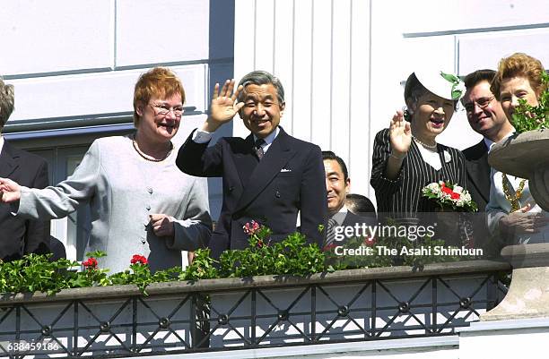 Emperor Akihito, Empress Michiko and Finland President Tarja Halonen greet well-wishers from a balcony during the welcome ceremony hosted by Helsinki...