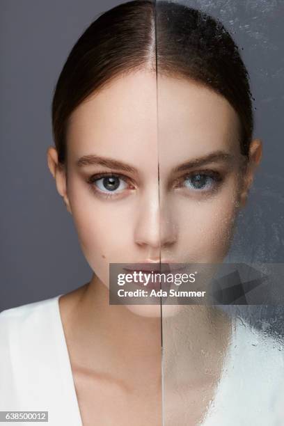 beautiful women half behind glas - menschliches gesicht fotografías e imágenes de stock