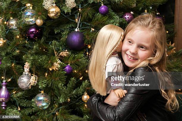 girl hugs doll at christmas - american girl doll stock pictures, royalty-free photos & images