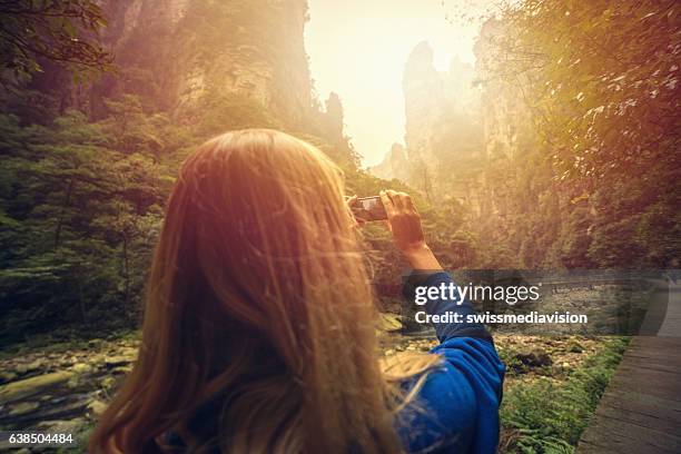 tourist hiking take smart phone picture-zhangjiajie national park - quartz sandstone stock pictures, royalty-free photos & images