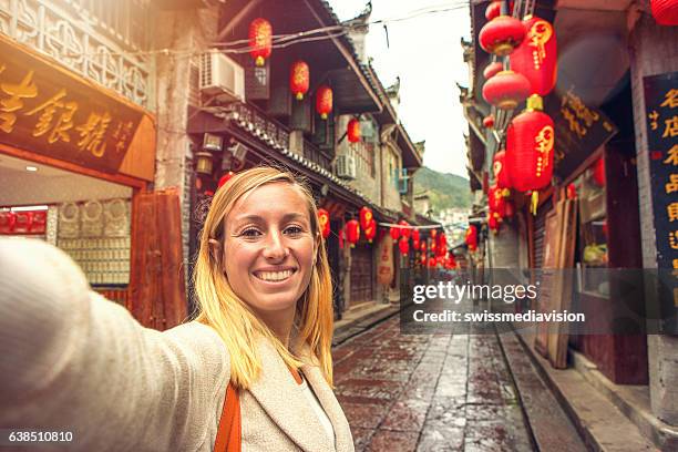 young woman in chinese street taking selfie portrait - china lantern stock pictures, royalty-free photos & images