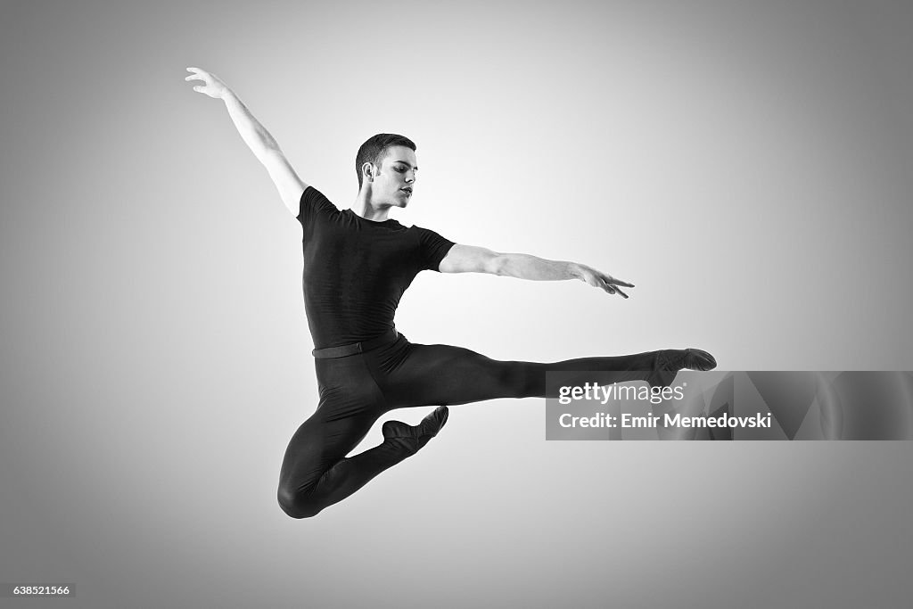 Black and white photo of a male ballet dancer jumping