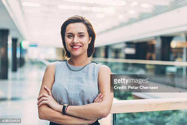 donna elegante in piedi all'interno dell'edificio aziendale - sales executive foto e immagini stock