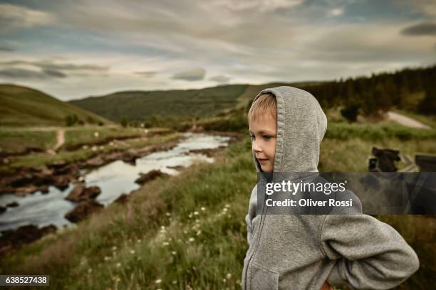 uk, scotland, boy wearing hoodie in rural landscpae - human age stock pictures, royalty-free photos & images