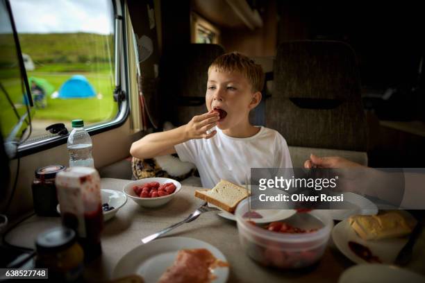Boy eating in recreational vehicle