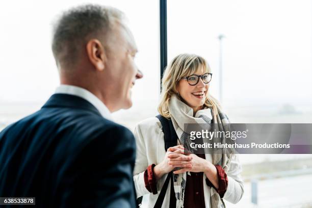 group of business people meeting at the airport and talking - business relationship stock pictures, royalty-free photos & images