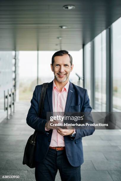 portrait of a businessman at the airport - business casual phone stock pictures, royalty-free photos & images