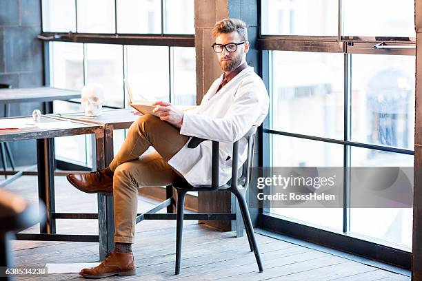 doctor working on medical research - doctor sitting stock pictures, royalty-free photos & images