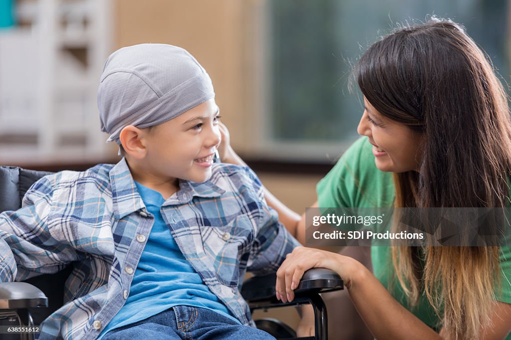 Mother comforts young son in hospital