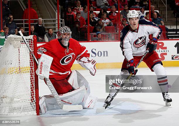 Cam Ward of the Carolina Hurricanes goes down in the crease to protect the net as Josh Anderson of the Columbus Blue Jackets looks to create traffic...