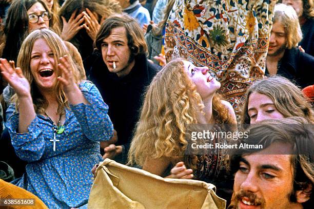 People in the crowd cheer as musical acts perform at the Altamont Speedway Free Festival on December 6, 1969 in Livermore, California.