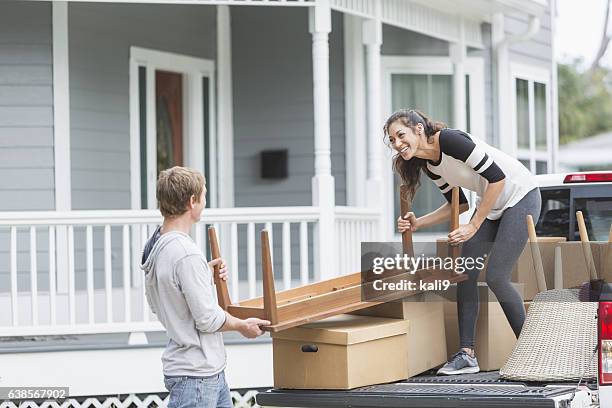 young couple moving furniture into new home - pick up truck stock pictures, royalty-free photos & images