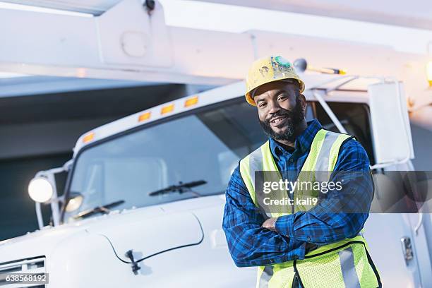 african american man with cherry picker truck - maintenance engineer stock pictures, royalty-free photos & images