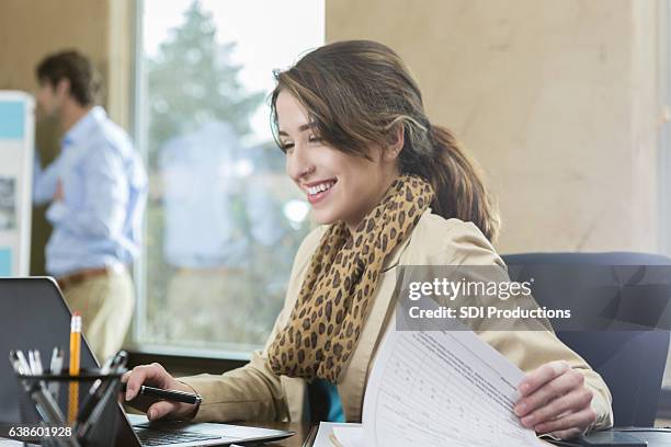 confident young businesswoman in the office - administrative professionals stockfoto's en -beelden