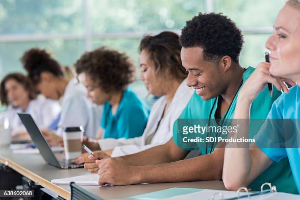 diverse pre-med students take notes during class - medical student stock pictures, royalty-free photos & images