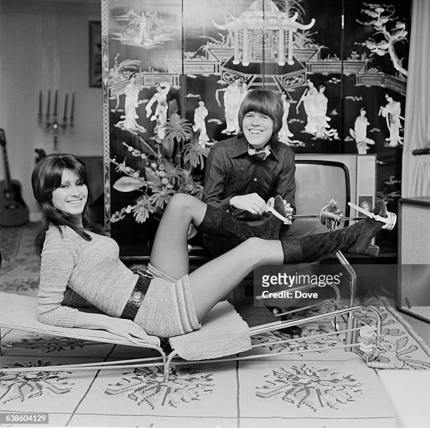 English singer and songwriter Peter Noone and his wife Mireille Noone testing a keep-fit machine, UK, 7th May 1971.