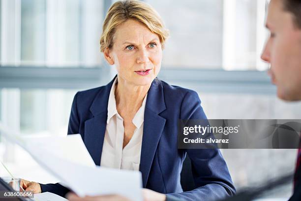 senior business woman discussing new project with colleague - styrelse bildbanksfoton och bilder