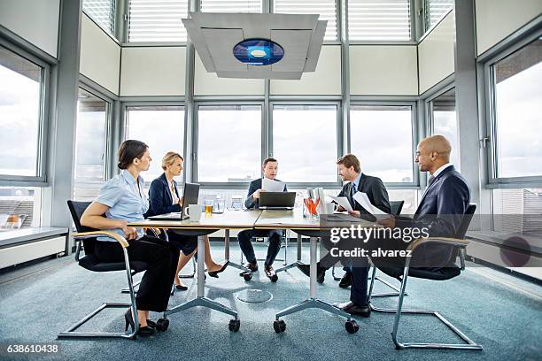 group of multi ethnic executives in a meeting - boardmember stock pictures, royalty-free photos & images