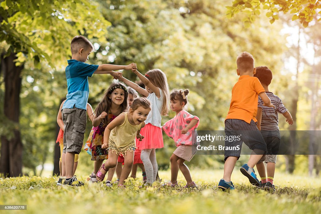 Group of small kids having fun while playing in nature.