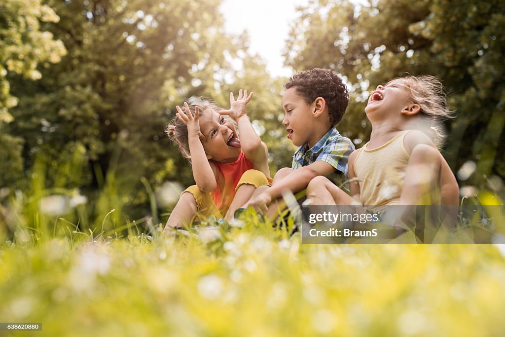 Small friends having fun while relaxing in grass.